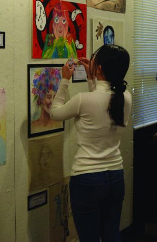 Junior art student Yeongyu Kang adds more to her art work during the school art show in December 2018. Photo by Athena Stamos