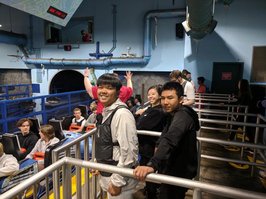 AP Physics students Andrew Chen (11), Zhirui He (10), and Christine Chen (10) wait in line for the Mr. Freeze ride at Six Flags. The vest Chens wearing recorded data on the Mr. Freeze that students would then use to answer various questions afterward. 