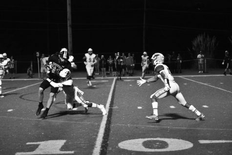 Wide receiver Cam Roberts catches the ball and trying to get more yards on a Marquette player. Roberts has caught 168 yards this season. Photo by Christine Stricker