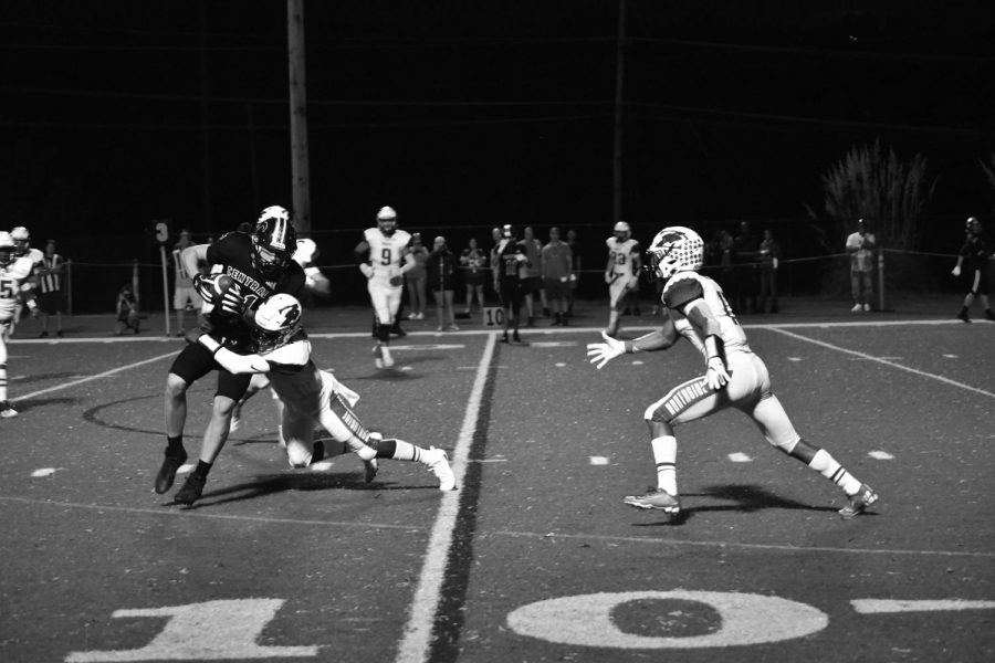 Wide receiver Cam Roberts catches the ball and trying to get more yards on a Marquette player. Roberts has caught 168 yards this season. Photo by Christine Stricker