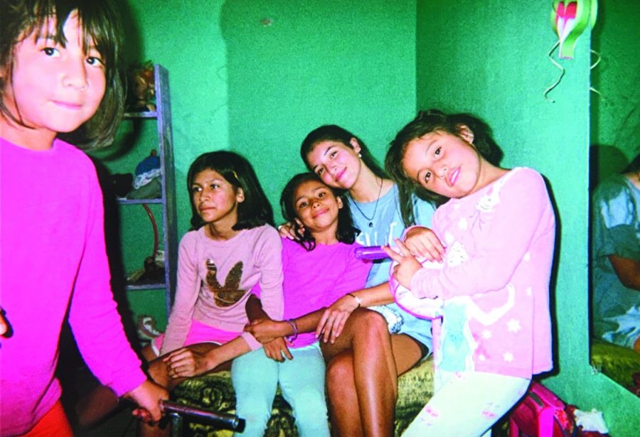 Senior Isabel Roman poses with children from Casa Hogar de San Juan. Photo courtesy of Isabel Roman.