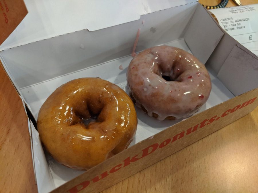 Pictured+here+are+the+classic+glazed+donut+and+the+%E2%80%9CSanta+Suit%E2%80%9D+donut+from+Duck+Donuts.+Not+pictured+is+their+warm+temperature.+Photo+by+Trey+Williams
