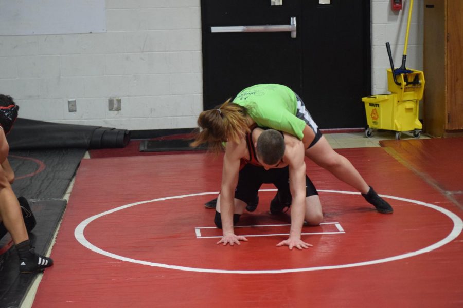 Freshman MJ Konieczny wrestling senior Joab Hackmann during practice. Due to Konieczny and Cox being in two different weight classes, the girls often have to wrestle other boys on the team. Photo by Alvi Lending.