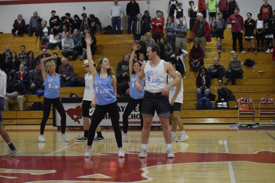 MacKenna Carpenter (12) and Anthony Klein (12) perform during half-time at the boys basketball game against Pattonville.
