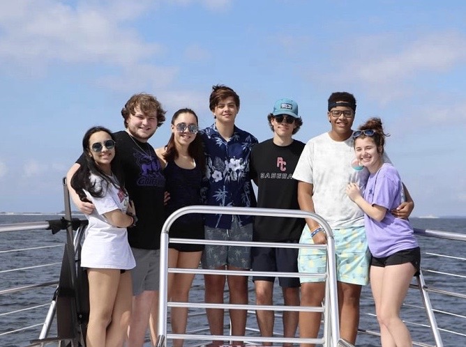 Adam Booker, Chris Stephens, Ryan Finley, Jack Ford, Sydney Stahlschmidt, Hannah Krivelow, and Emily Enlow on a boat in Alabama.