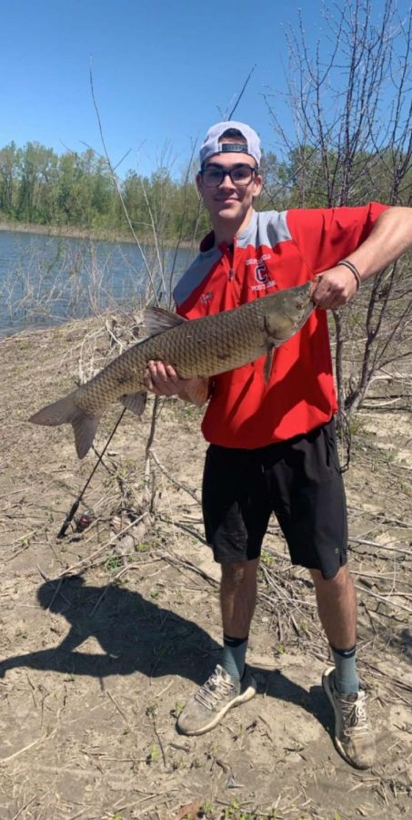 Senior Jack Ford with his big catch of the day. He caught a common carp. Photo by Haydn Schertz.