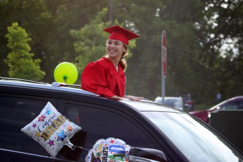 Sivan Rodin looks back at classmates in the parking lot start of the Class of 2020 parade on May 27, 2020. Graduation has been pushed back until July 28 due to coronavirus, so the parade helped the grads feel celebrated. 