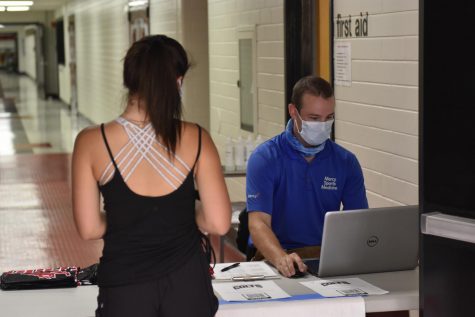 Ava Wittner, Junior checking in with trainer at the first day of practice, Sept.24.