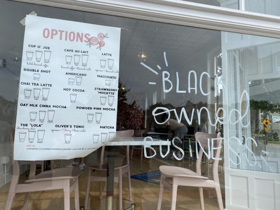 The outside of C. Oliver showing the menu and the black owned business sign. Photo taken by Gabby Abowitz. 