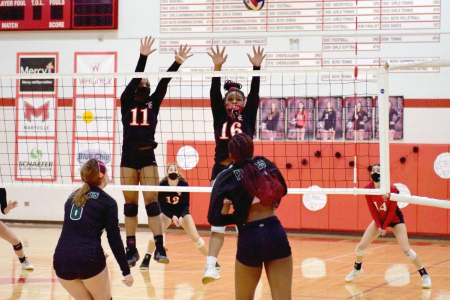 Junior Kaye Tate and senior Deja Campbell go up for a block in the Senior Night game against Pattonville on Oct. 21.