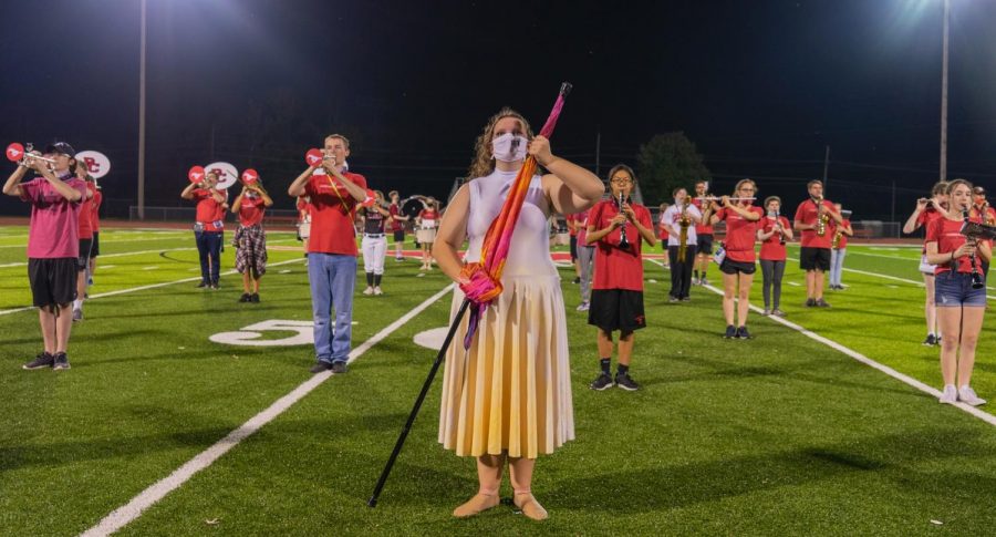 The color guard and marching band perform together at a football game on Oct. 7, 2020. “My favorite part would have to be waking up early in the morning with everyone else and just getting there
early to watch the sun rise while doing a bunch of other stuff with the band and everything,” freshman Anastasia Lindholm said.
