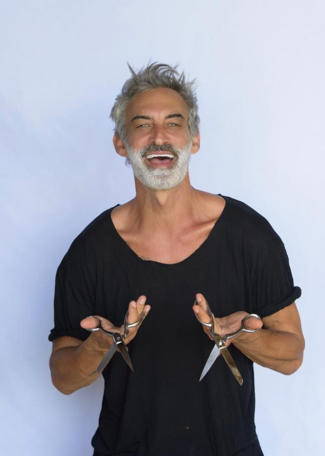 Adam Saaks poses for his promo shot with two pairs of scissors.