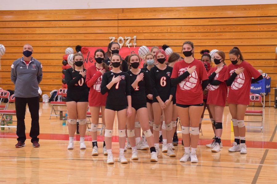 Girls volleyball stand for the pledge before a game on October 21, 2020. When we do add the pledge to sporting events, people don’t really see the significance of it, Sivabalakannan said. Were being brainwashed to pledge allegiance to a country when we’re not soldiers in the military or in the navy, because we’ve been taught to do it from such a young age.” Photo by Christine Stricker.
