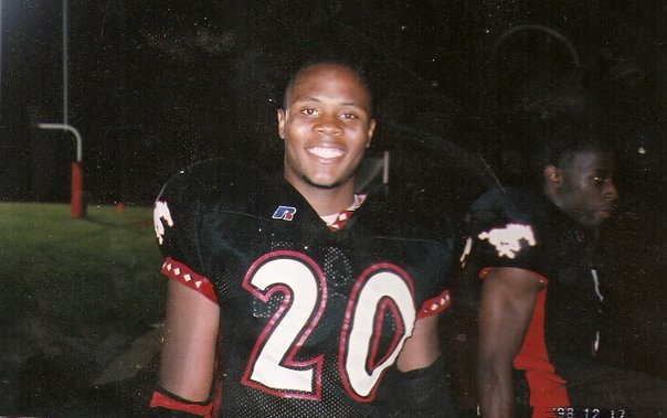 Cockrell, smiling and wearing his football jersey, stands on the Central field in 1998.