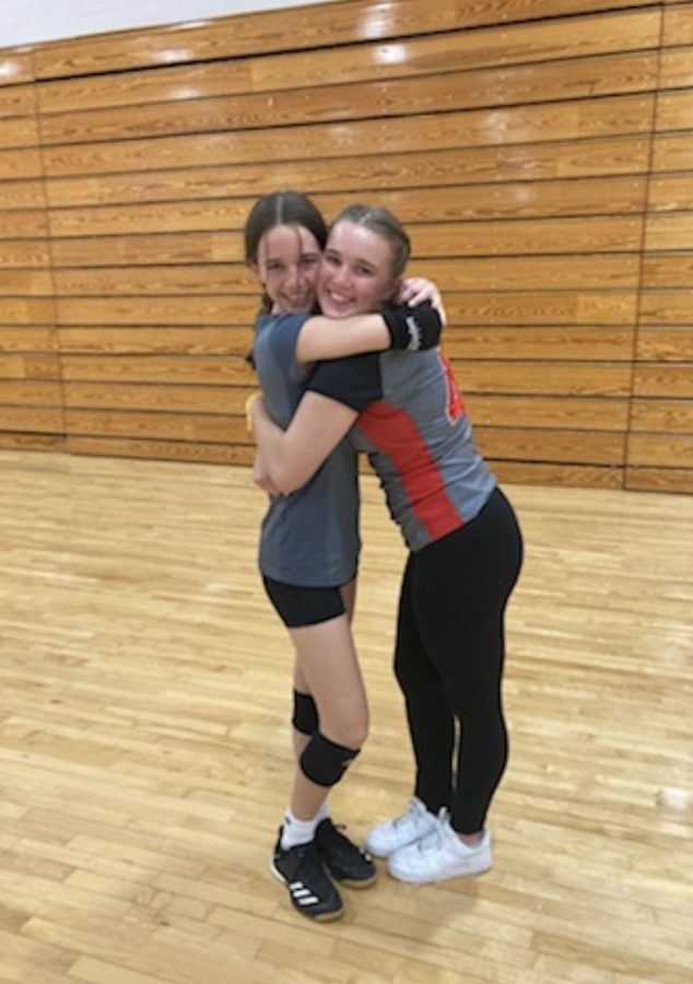 Lana (right) and Keri (left) Piepho hug. The sisters play volleyball together. 