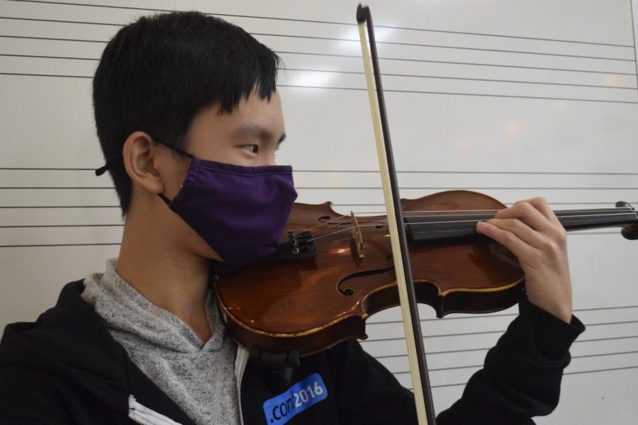 Asher Koh (9) playing violin during ac lab.
