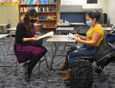 ESOL teacher and avid reader Kathryn Ott reads with student Lizette Diaz Arenas (10). Photo by Alyssa Weisenberg