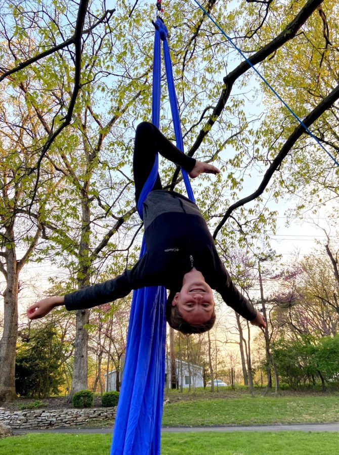 Henroid dangles on aerial silks. “Every winter and spring there are student showcases when you get to choreograph your own piece and show it off in front of friends and family,” Henroid said. “Just a few months ago, I did a piece with my sister and that was really fun. I was really proud of that.” Photo by Amanda Henroid.
 
