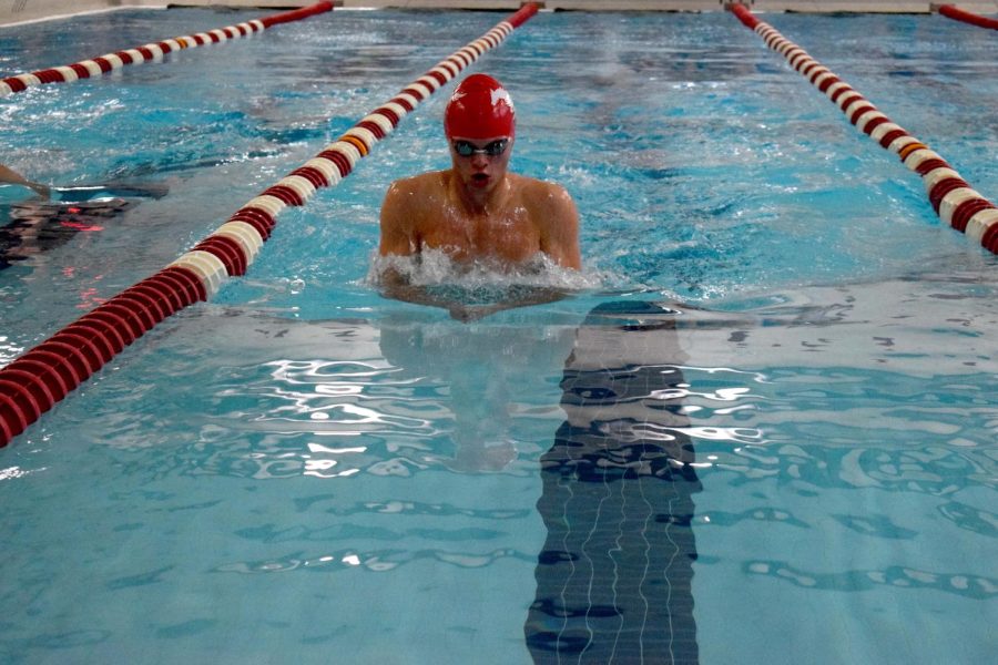 Senior Jake Hansen swims the breaststroke during Senior Night on Oct. 11. Photo by Alyssa Weisenberg. 