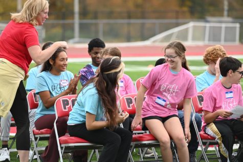 Freshman Lily Gerbic smiles with senior Camila Mantilla as they sit down after Gerbic gave a speech at the Special Olympics Opening Ceremony. 