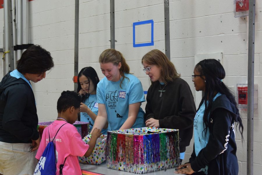 Students hand out awards in the carnival located in Gym A. Prizes were won amid activities such as mini golf, four square, and face painting.