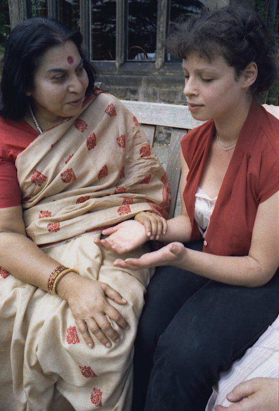 Shri Mataji Nirmala Devi, the founder of Sahaja Yoga (left), teaches beginner Sharon (right) how to meditate in Sheffield UK 1981.