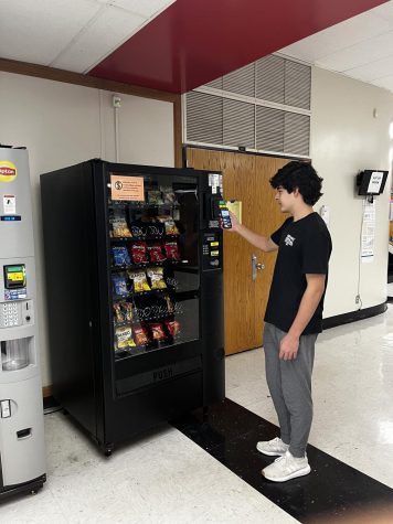 Sophmore Alan Conway uses the vending machine to buy a bag of chips during lunch.