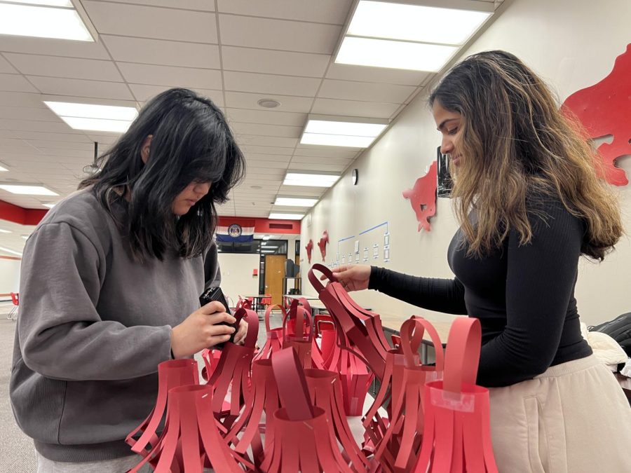 Christine Chen (11) and Ann Joseph (11) work on lanterns for the Lunar New Year celebration in the Social Studies Commons on Jan. 27