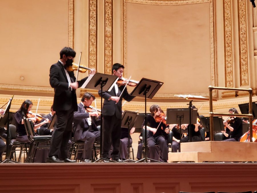 Freshman+Aiden+Moon+and+Sophomore+Asher+Koh+play+at+Carnegie+Hall+on+April+6.+They+are+the+violin+first+chair+and+second+chair%2C+and+they+perform+a+duet+together.+Photo+by+Wooin+Robinson.