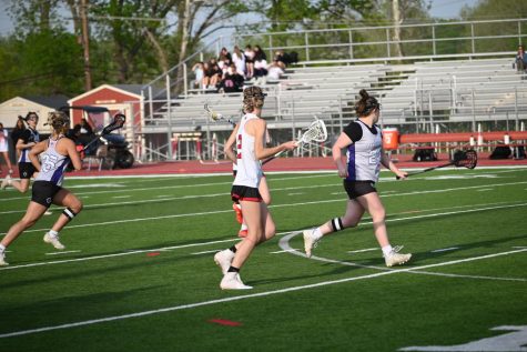Senior Anna Aslin passes the ball down the field in a game against Fort Zumwalt. Photo by Zoe Klevens.