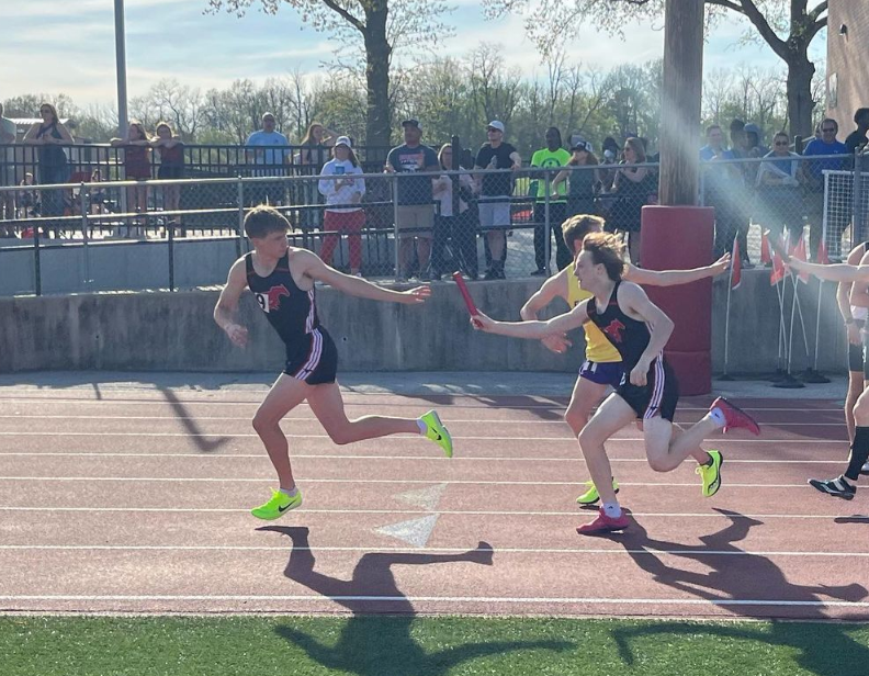 Sophomore+track+and+field+athlete+Alex+Moresi+exchanges+the+baton+with+Sophomore+Beckett+Friedman+during+the+Henle+Holmes+Invite+held+at+Parkway+Central+High+School+on+April+14th.