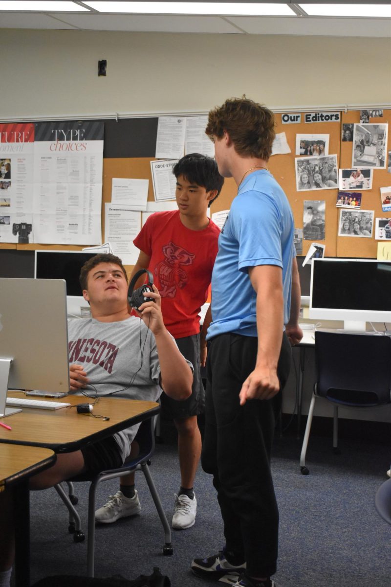 Senior Ethan Albin talks with senior Sam Sailors and junior Landon Chen about a project. journalism is a fun way for me to combine my love of sports and my love of media, Albin Said. 