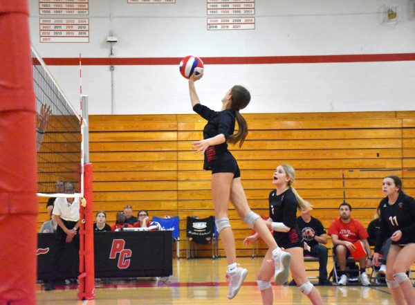 Maddie Schaefer (9) tips the ball over the net at a home game against Parkway South on Oct. 4. The Colts won in full sets and ended with a score of 3-0.
