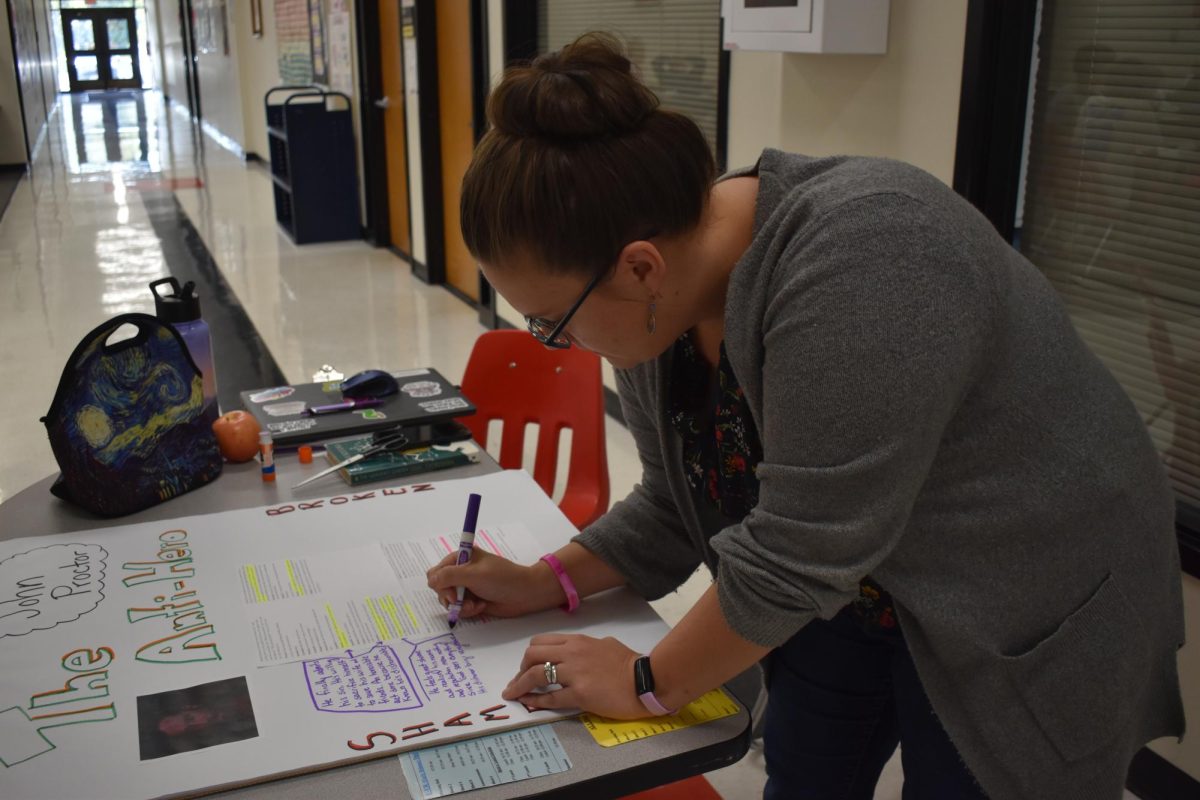 English teacher Mattie Rudolph prepares for class during her hallway supervision time on Sept. 27  in the social studies commons. While it once was her plan time, she now needs to get her work done outside of the classroom. 