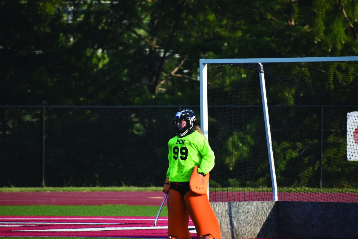 Varsity goalie sophomore Caroline Greene marks up on a player with others defending her. Greene has racked up 43 total saves. 