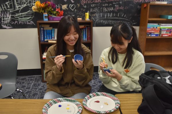 Seniors Hanquing Yin and Zoe Wang paint diyas (traditional oil lamps) at the Diwali festival hosted by the International Club on Nov. 11.