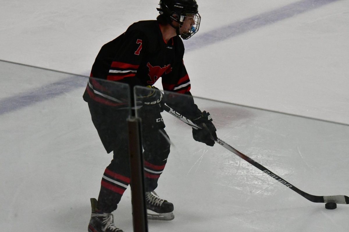 Senior+captain+Blake+Huelskoetter+skates+with+the+puck+at+mid-ice+during+a+practice+game+against+St.+Dominic+on+October+17th+at+Wentzville+Ice+Arena.+Photo+by+Ethan+Albin