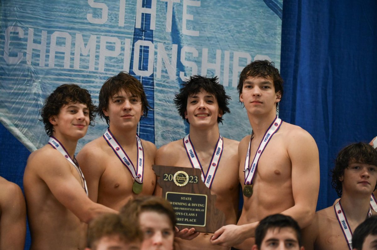 Tyler Bryant (12), Connor Muran (9), Brody Blatt (10), and Will Jost (12)  hold their first place Boys Class 1 trophy at the state championship on Nov. 10 at the St. Peters Rec-Plex. Two championships in two years, the boys swim and dive return for another win this season. Photo by Mary Bezzant.