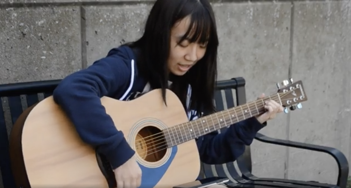 Zoe Wang (12) plays the guitar at school on Sept. 25. 