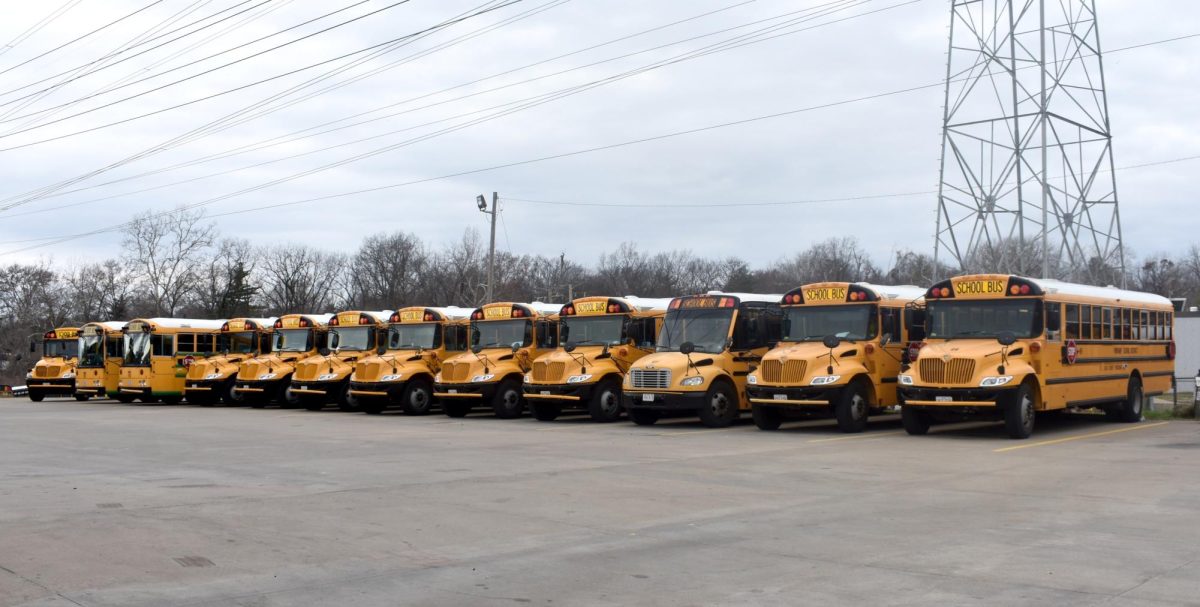 Parkway buses await student riders in the transportation lot. Photo by Esther Wang