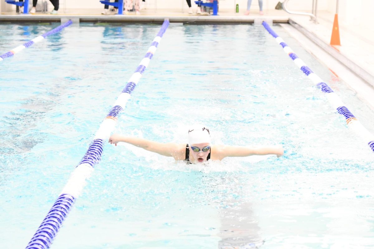 Senior Alyssa Weisenberg, takes a breath during her race at the conference meet at Clayton. “I placed 17th at state in the 500 and dropped .2 seconds in the 100 butterfly,” Weisenberg said
