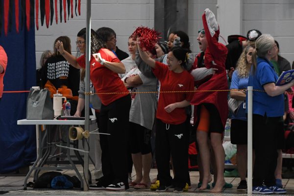The Colts swim team cheers on their teammates after a race. The girls team placed 4th in the state meet. 