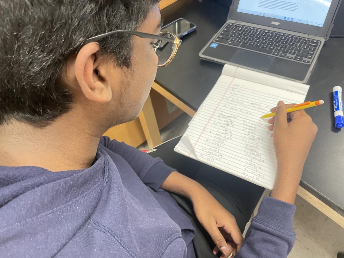 Jason Mathew (9) works on his AP physics 1 homework on Feb 15. Typically, Freshman do not take AP Physics 1 because it requires concurrent or previous enrollment in Algebra 2 Trigonometry, Mathew meets this requirement because he is also ahead in mathematics taking Honors Algebra 2 Trigonometry.
