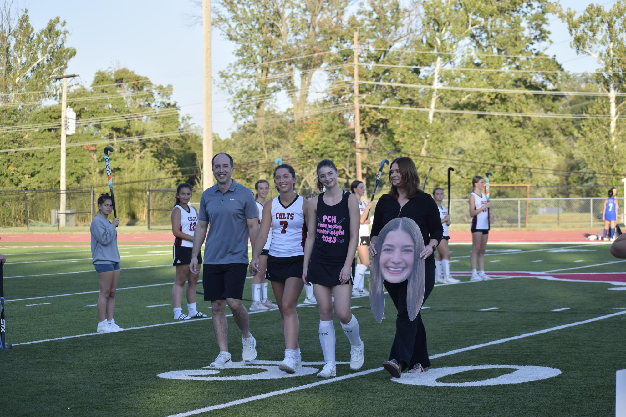 Allison Colozza (10) walks with her sister Julia Colozza (12) on senior night versus Notre Dame on Oct. 2. 