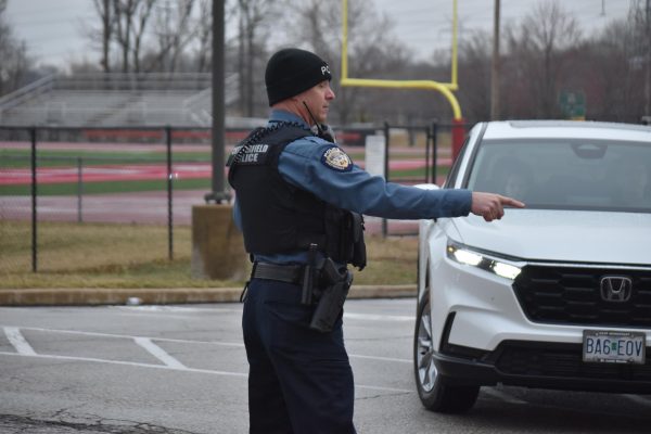 Officer Kaatmann controlling the traffic on Stadium Drive