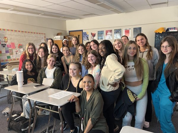 The Sister Project Club poses for a picture in Marissa Farrell’s classroom at a meeting after school. 