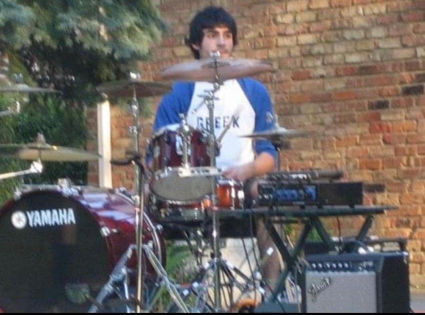 Peter+Papulis+plays+the+drums+during+a+backyard+concert.