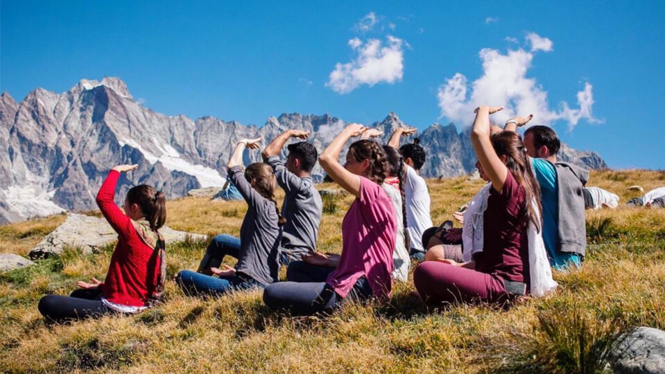 Young adults meditating in nature. Photo courtesy of Sahaja Yoga Meditation USA.