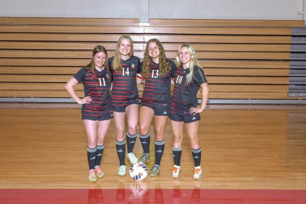 Molly Huss (12), Ellie Sioumcas (12), Kaitlyn King (12), and Gabby Spicuzza (12), pose for media day at Parkway Central. These seniors work on their team bond from the very start of the season. 