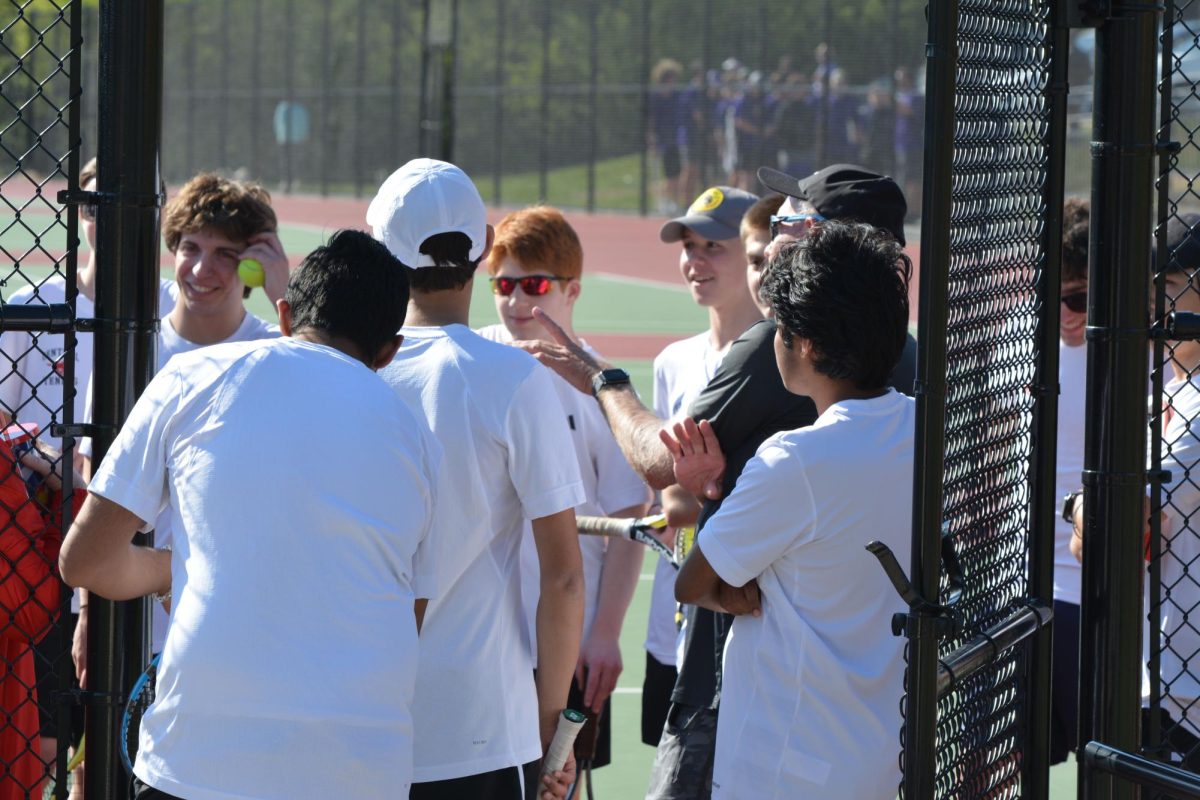 The boys tennis team wraps up their game against Eureka together with Coach Hays.
